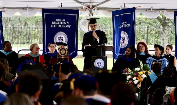 A member of Faculty Senate speaking at Convocation