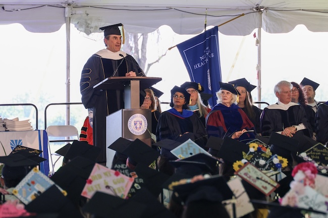 Keynote speaker Louis P. Kassa III speaking at the podium during commencement