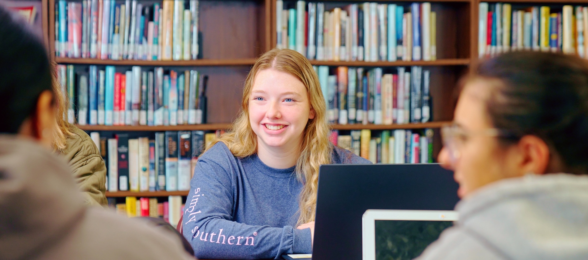 Three students in the Library studying at a table
