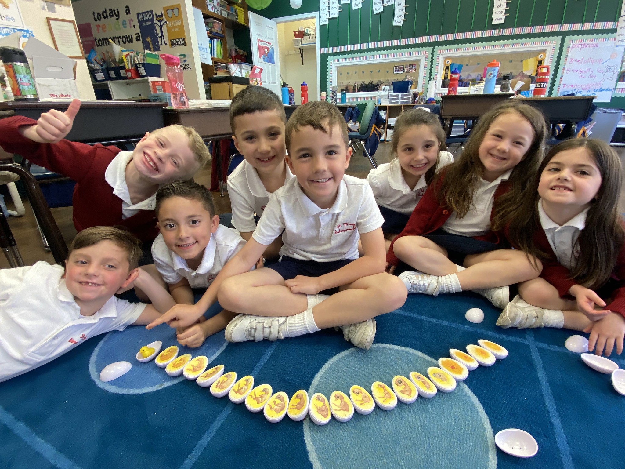 A group of smiling students in their classroom