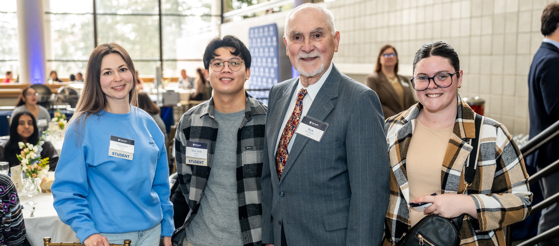 A donor and three HFU students smile at a donor celebration on campus