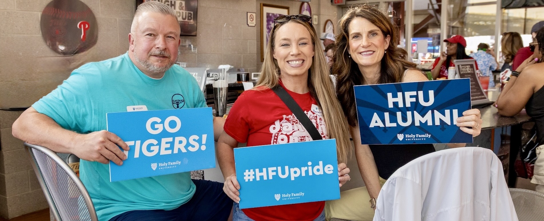 Three HFU alum celebrating at Phillies game