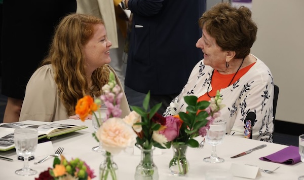 An younger and more senior alum connect during an alumni association event