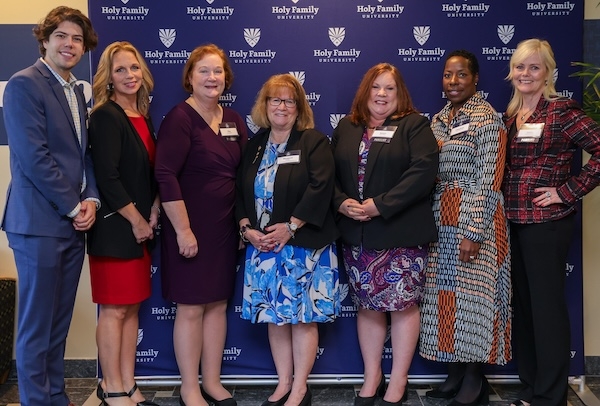 A group shot of alums, including Chaudron Carter Short, celebrating at an event