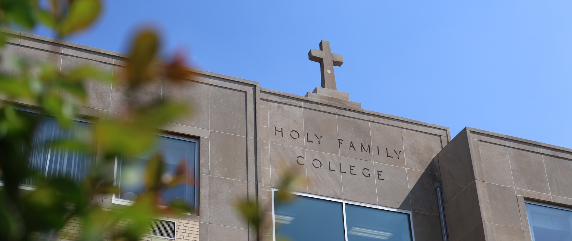 The exterior facade of an HFU building with "Holy Family University" engraved in it