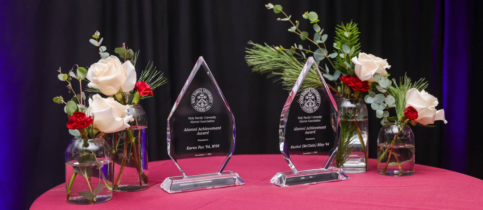 A decorated table with engraved awards displayed on them