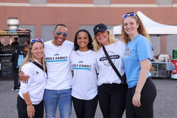 Five Holy Family alumni gather on campus for an event