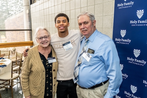 An HFU student poses with two HFU alum who helped support his education