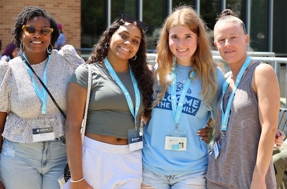 Two new HFU students at an orientation event with their mothers