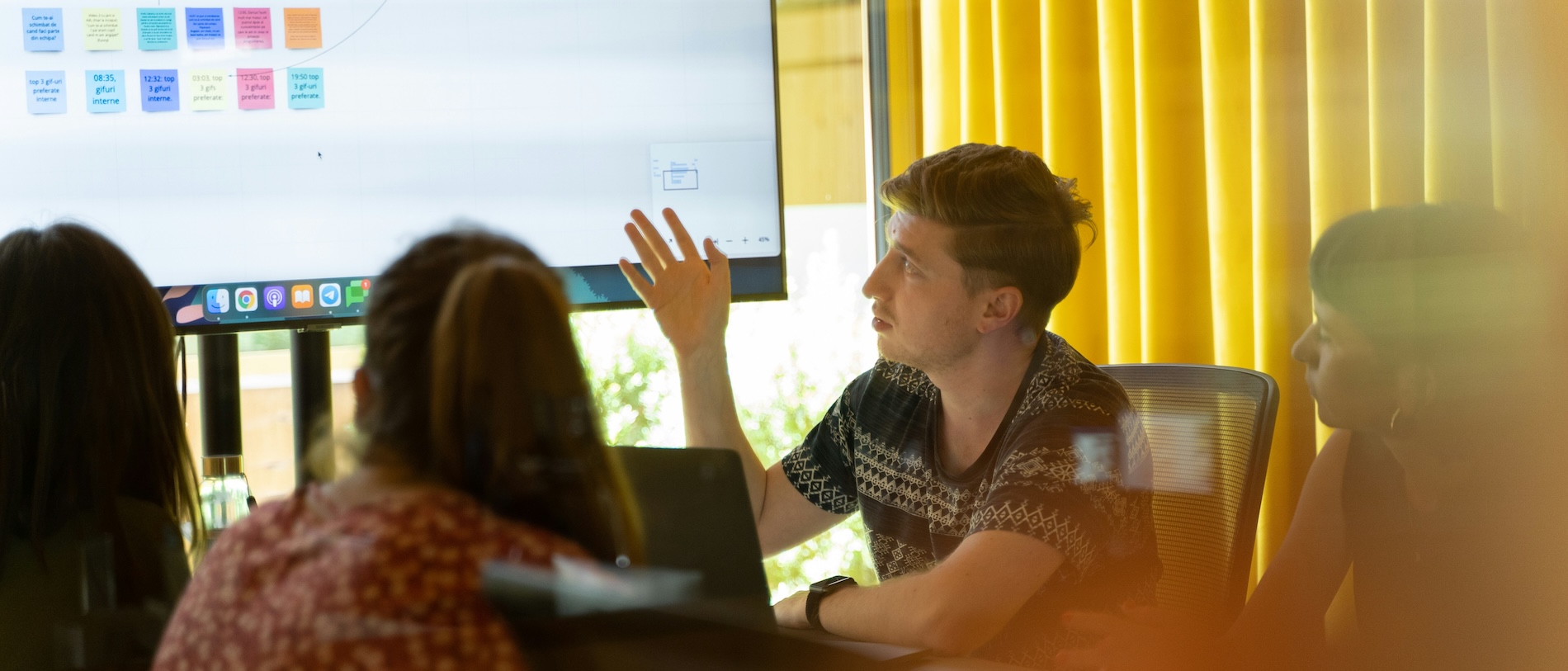 A grad assistant presenting to colleagues in a conference room