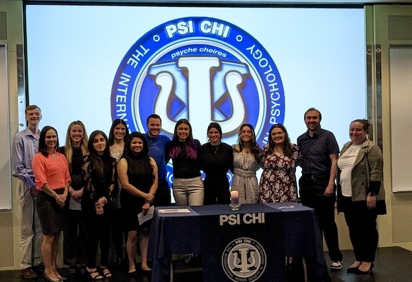 HFU's Psi Chi chapter on stage together after a presentation