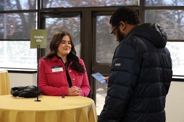 Alum meeting with a student at a function on campus