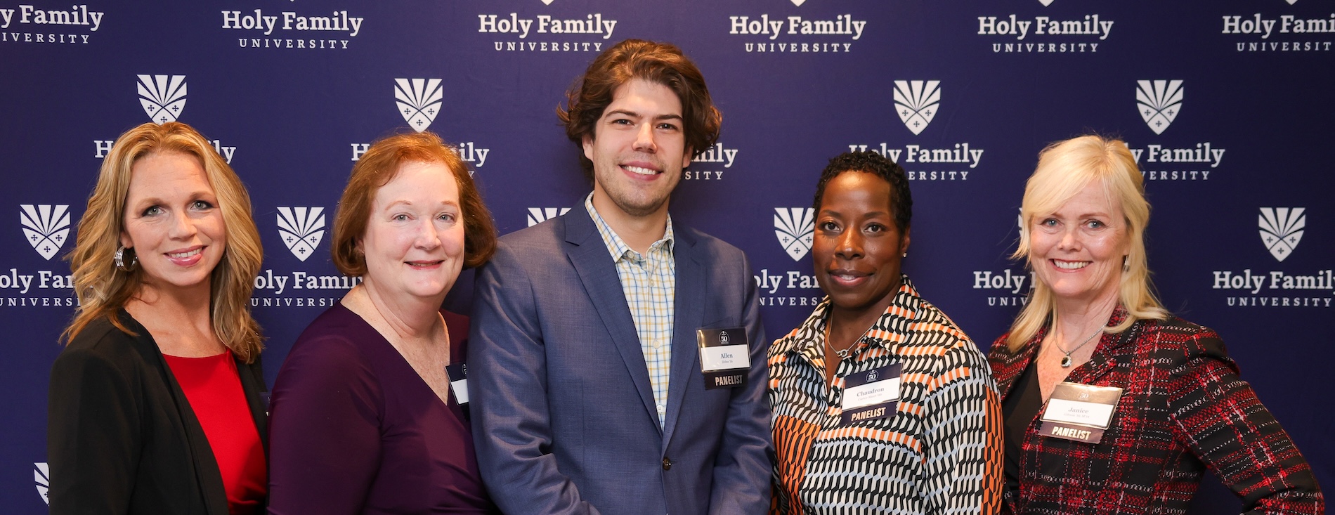 Student with four alums posing at networking event