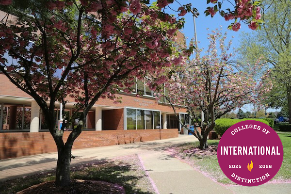 Trees and the exterior of a campus building with the "International Colleges of Distinction 2025-2026" badge on it