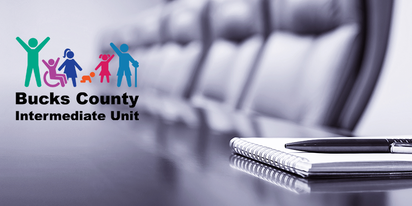 A conference room with the Bucks County Intermediate Unit logo